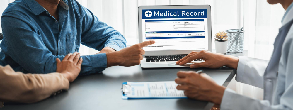 a doctor going over medical records with patient and their anuual health screenings