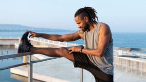 an African American man doing leg warm-before a workout
